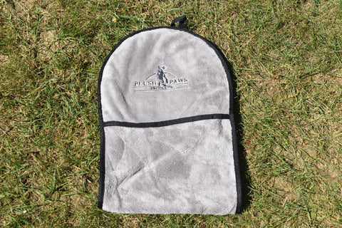 Gray pet product with 'Plush Paws' logo on grass